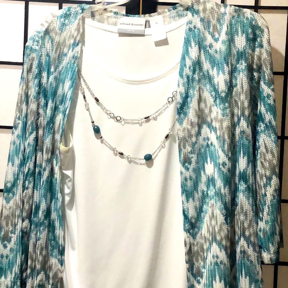 A blouse with an attached necklace .